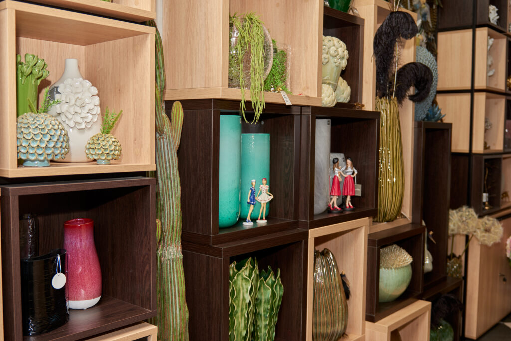 Various built-in shelf designs for gallery walls including floating wood shelves, metal brackets, and picture frame shelves with small potted plants arranged for display