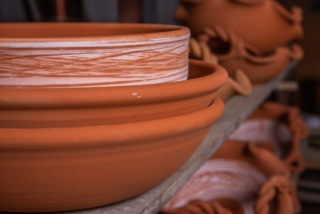 Side-by-side comparison of terracotta and glazed ceramic pots highlighting material texture.